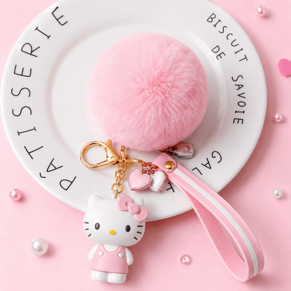 Hello Kitty keychain with pink pom-pom on a pink background