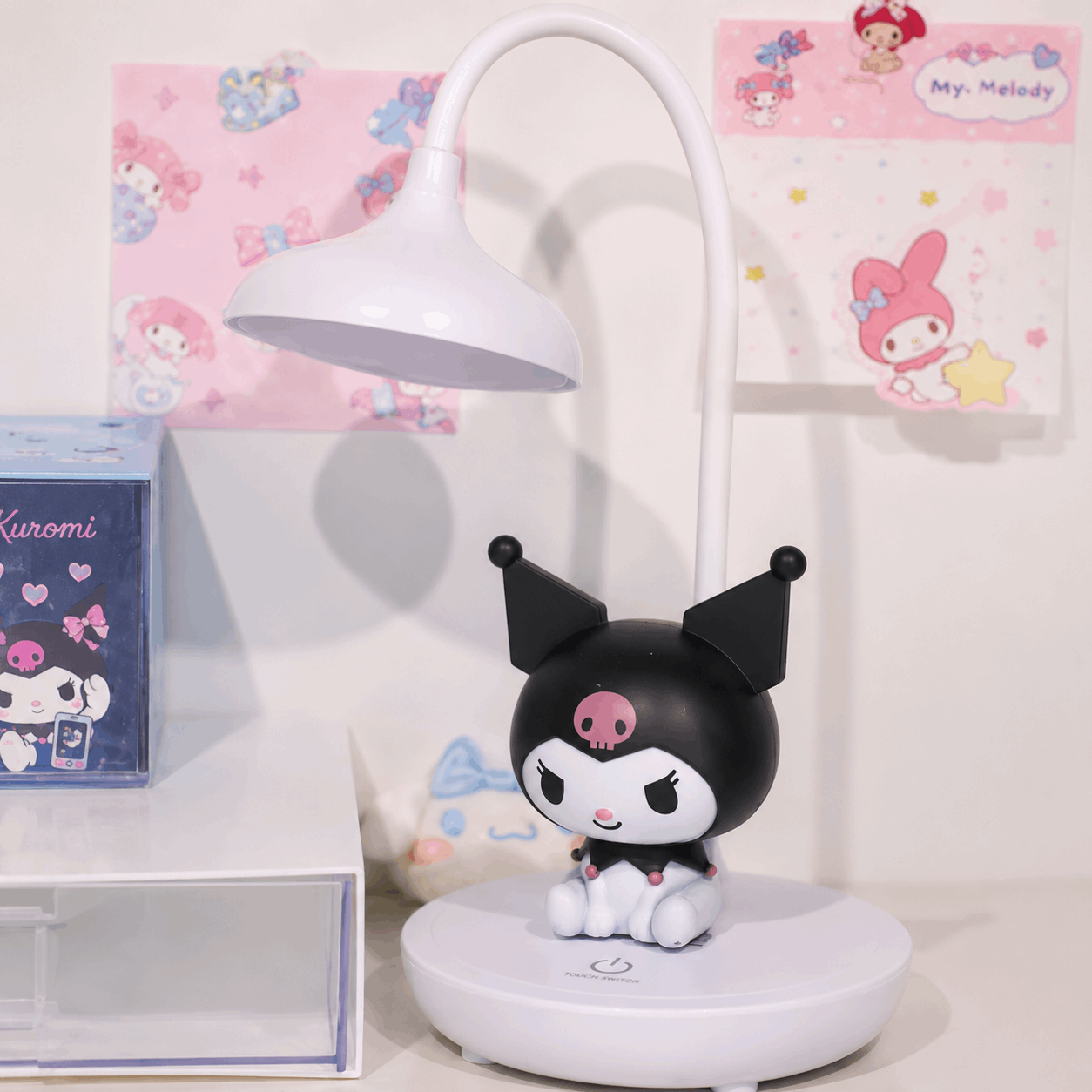 Black and white character figurine on a stand with a lamp in the background