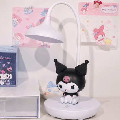 Black and white character figurine on a stand with a lamp in the background