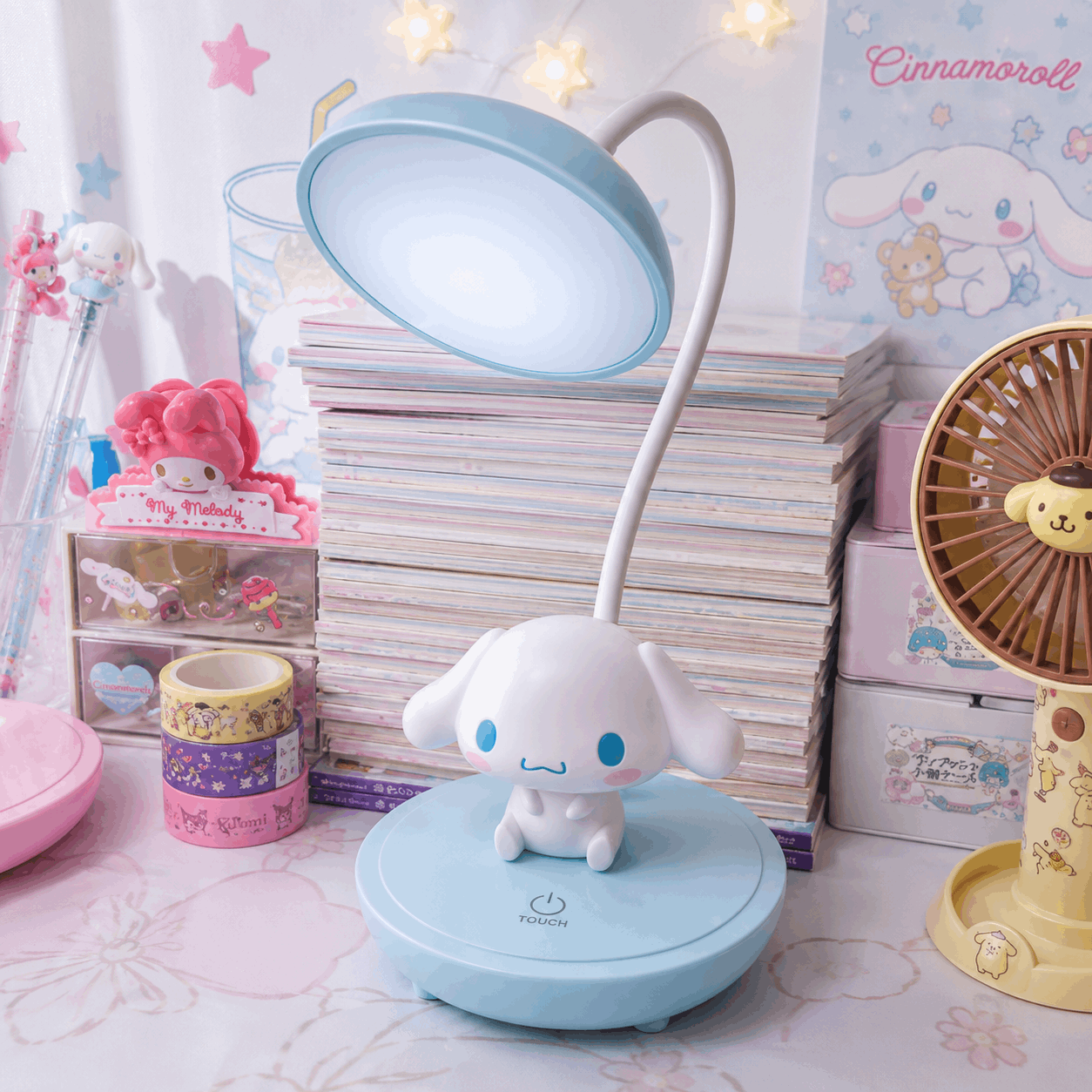 Cute desk lamp with cartoon character on a desk with stationery items