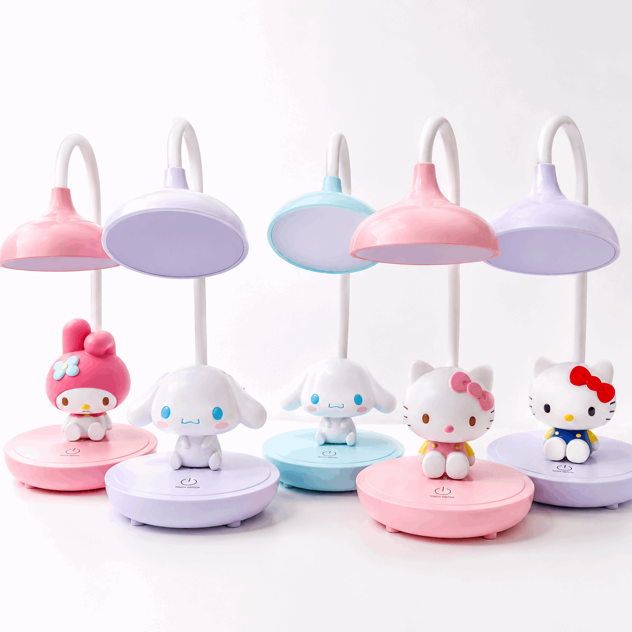 Set of colorful cartoon character desk lamps on a white background