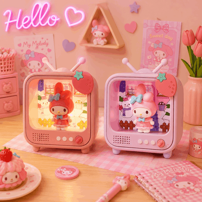 Two pink toy televisions with character displays on a decorative table.