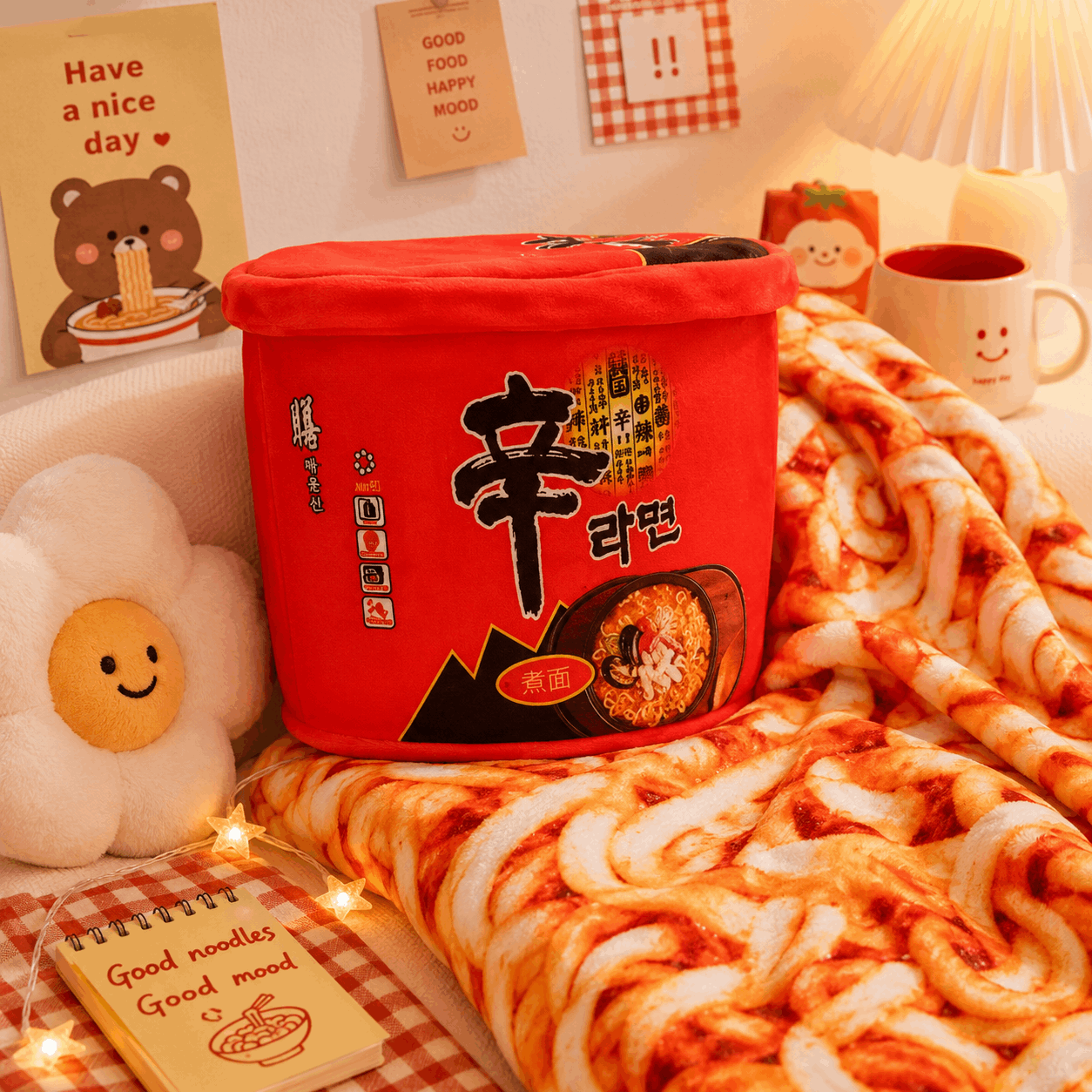 Red noodle bucket with Korean text on a bed with noodles and a notebook