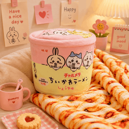 Pink and yellow container with cartoon characters on a cozy blanket with pizza and coffee.