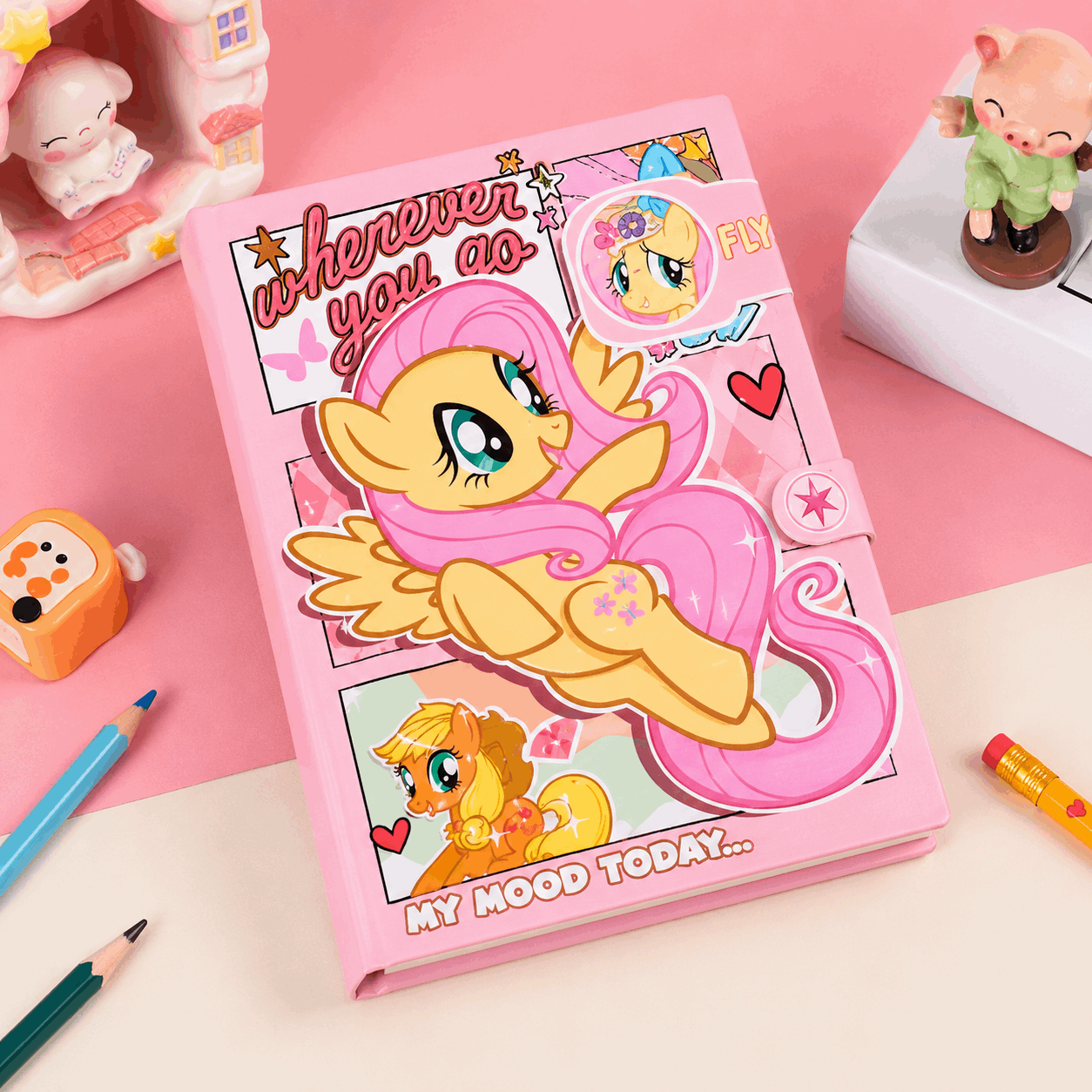 Pink notebook with cartoon pony design on a pink background