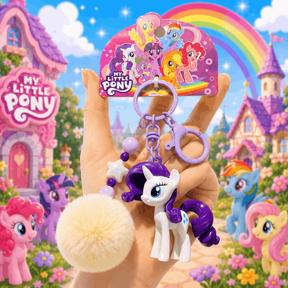 My Little Pony keychain held in front of a colorful background with cartoon houses and ponies.