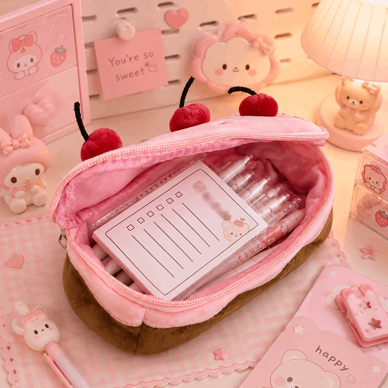 Pink stationery set with a heart-shaped pouch on a pink background