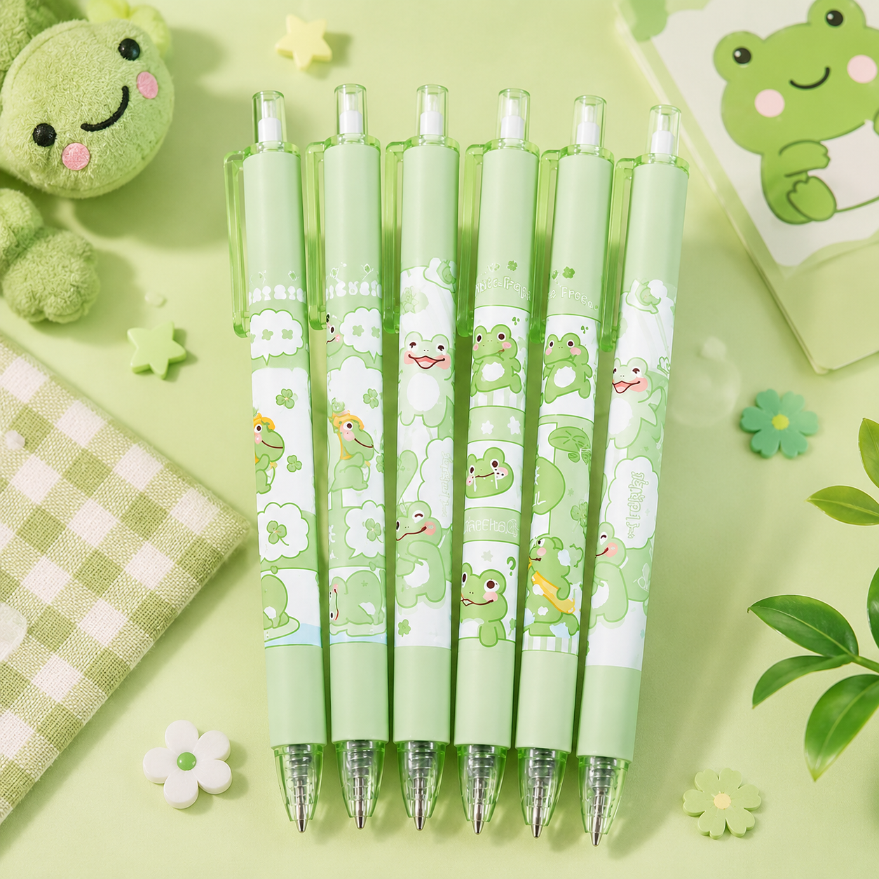 Set of green pens with frog designs on a green background