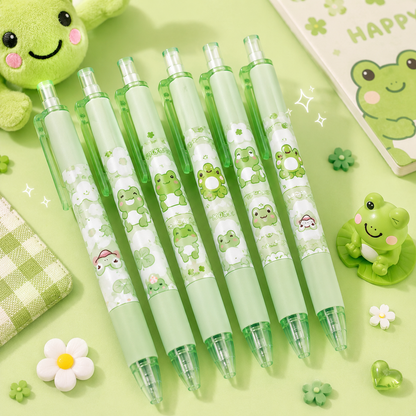 Set of green pens with frog designs on a light green background
