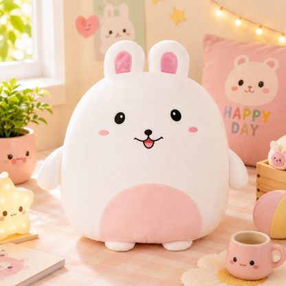 Cute plush toy with bunny ears on a soft surface with decorative items in the background