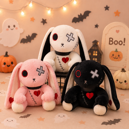 Three plush toys shaped like bunnies with Halloween-themed decorations in the background.