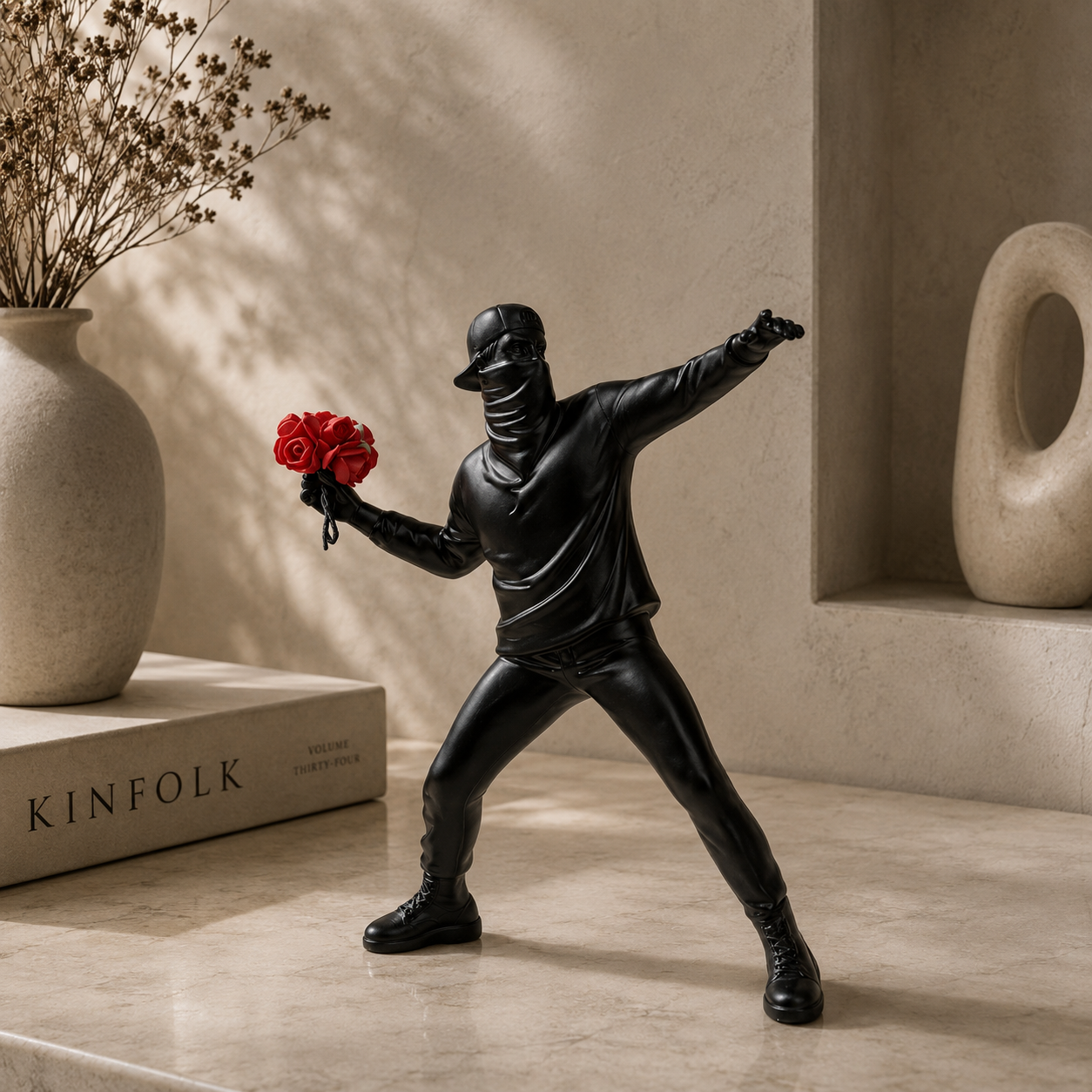 Black ninja figurine holding red roses in a minimalistic setting with 'KINFOLK' magazine.