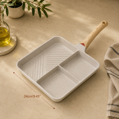 Small frying pan with wooden handle on a beige surface, with a plant and oil bottle in the background.