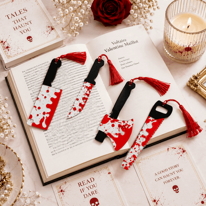 Decorative bookmarks with red and white design on an open book, surrounded by books and a candle.
