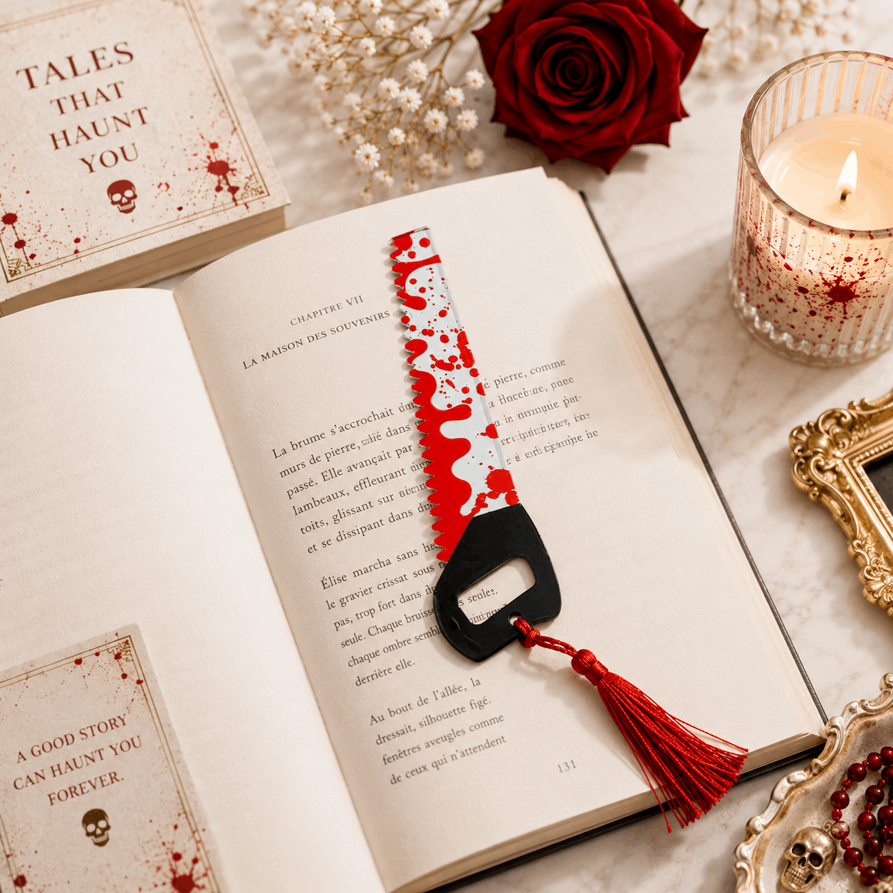 Open book with a red and black saw-shaped bookmark on a marble surface with a candle and rose.