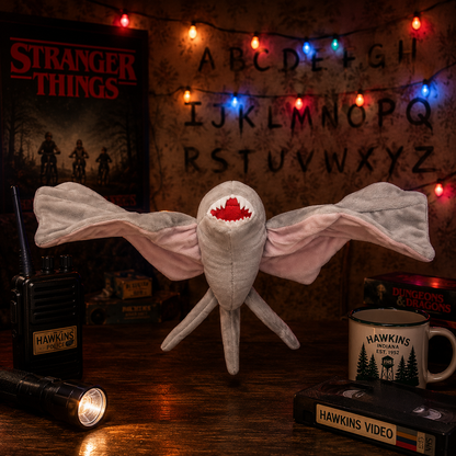 Stranger Things-themed plush toy with decorative lights and props on a wooden surface.