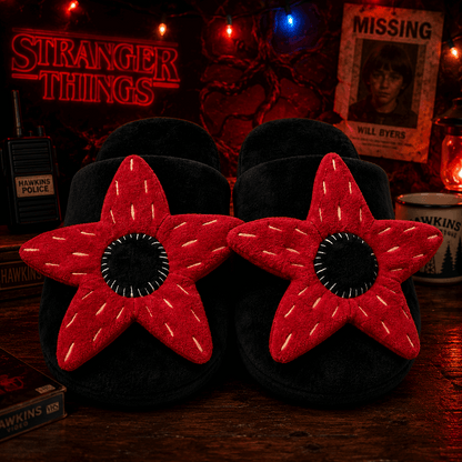 Black slippers with red star design on a dark background with 'Stranger Things' theme.