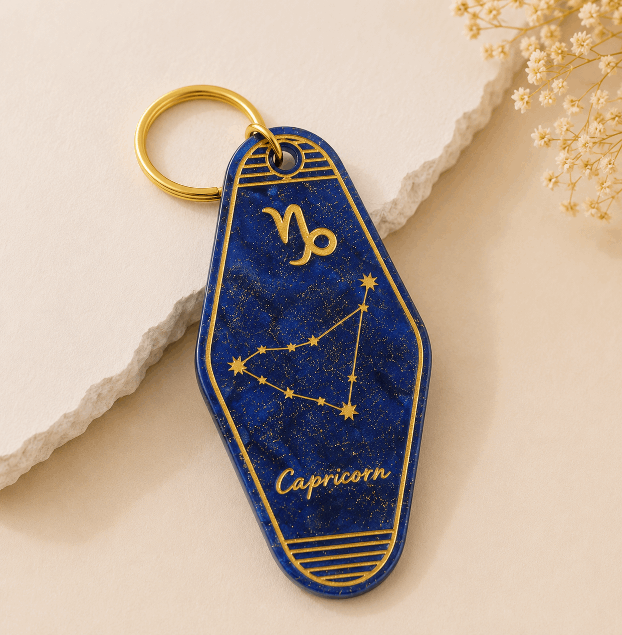 Keychain with Capricorn zodiac design on a beige background
