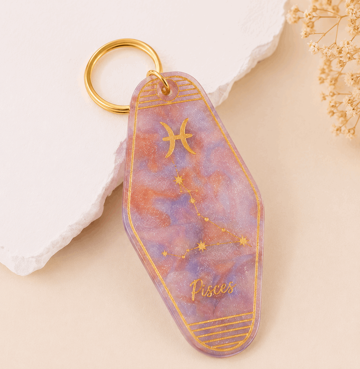 Keychain with zodiac design on a decorative background