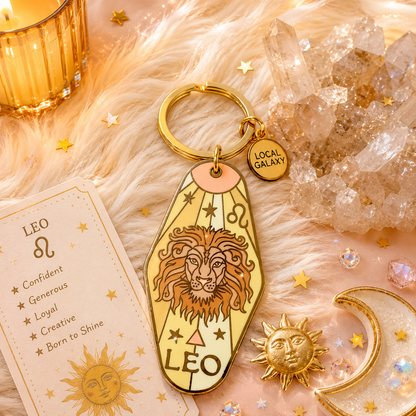 Gold Leo zodiac keychain with crystal and candle on fur background