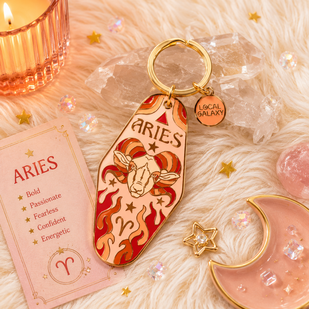 Keychain with Aries design on a soft fabric background with decorative items.