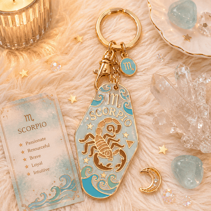 Scorpio zodiac keychain with astrological card on a soft surface with crystals and candles.