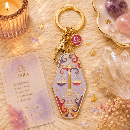 Libra zodiac keychain with card on a decorative surface with crystals and candles