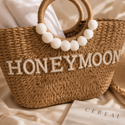 Woven bag with 'HONEYMOON' text on a soft surface