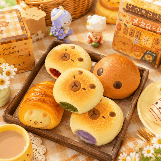 Baked goods with bear faces on a wooden tray, surrounded by decorative items and a cup of coffee.