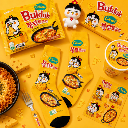Buldak Cheese Hot Chicken Noodle packaging and products on a yellow background