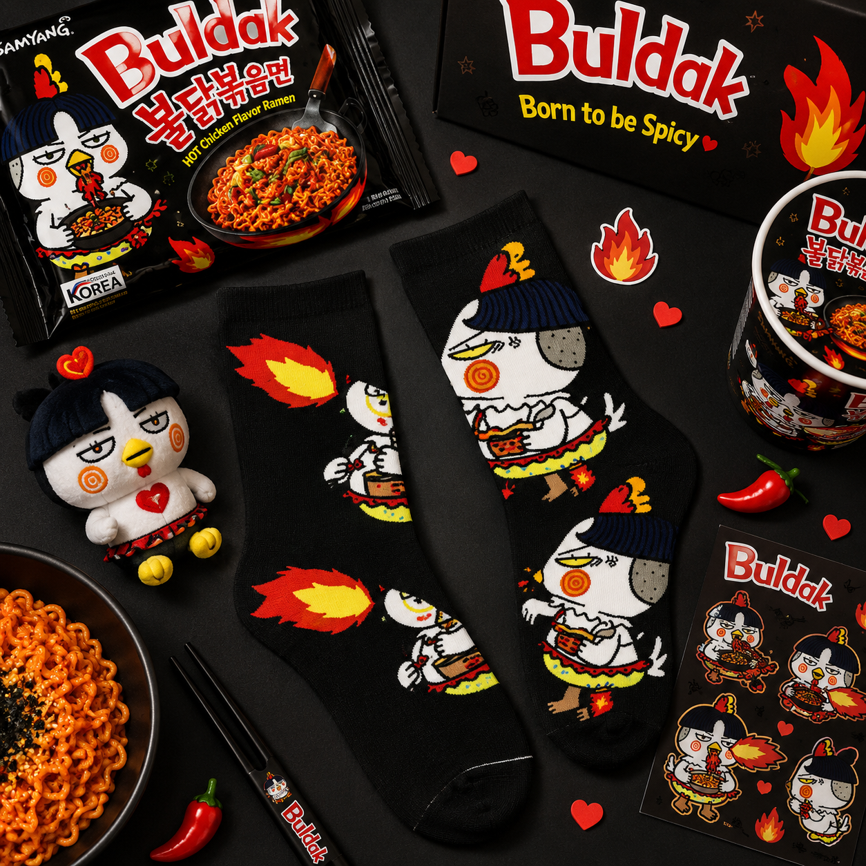 Buldak spicy chicken-themed products including socks, plush toy, and packaging on a dark surface.