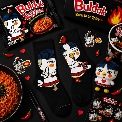 Buldak spicy noodle packaging with cartoon character, socks, and mug on a black background