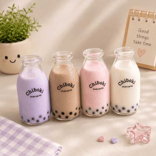 Four glass bottles of Chiboki bubble tea on a light surface with a plant and decorative item in the background.