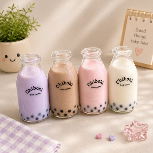 Four glass bottles of Chiboki bubble tea on a light surface with a plant and decorative item in the background.