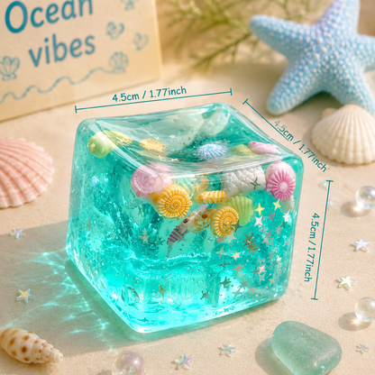 Clear resin cube with sea-themed decorations on a sandy background with 'Ocean vibes' text.
