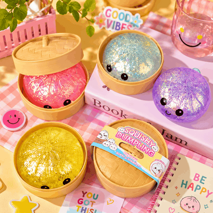 Squishy dumplings with colorful glittery centers in wooden containers on a pink checkered background.