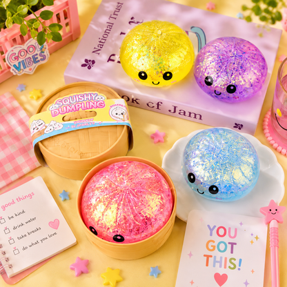 Colorful squishy toys with smiling faces on a yellow surface with stationery items.