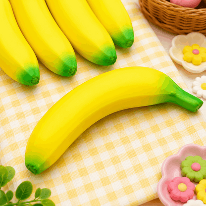 Yellow bananas with green tips on a checkered tablecloth