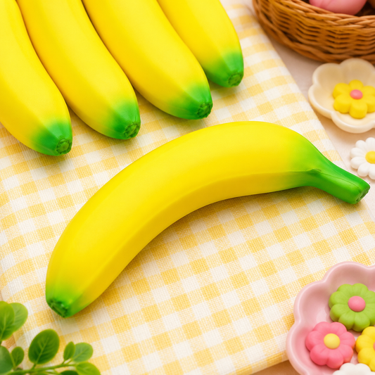 Yellow bananas with green tips on a checkered tablecloth