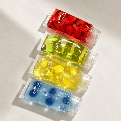 Four small bottles of Chiboki squishy toys on a light background