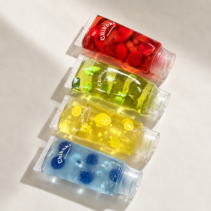 Four small bottles of Chiboki squishy toys on a light background