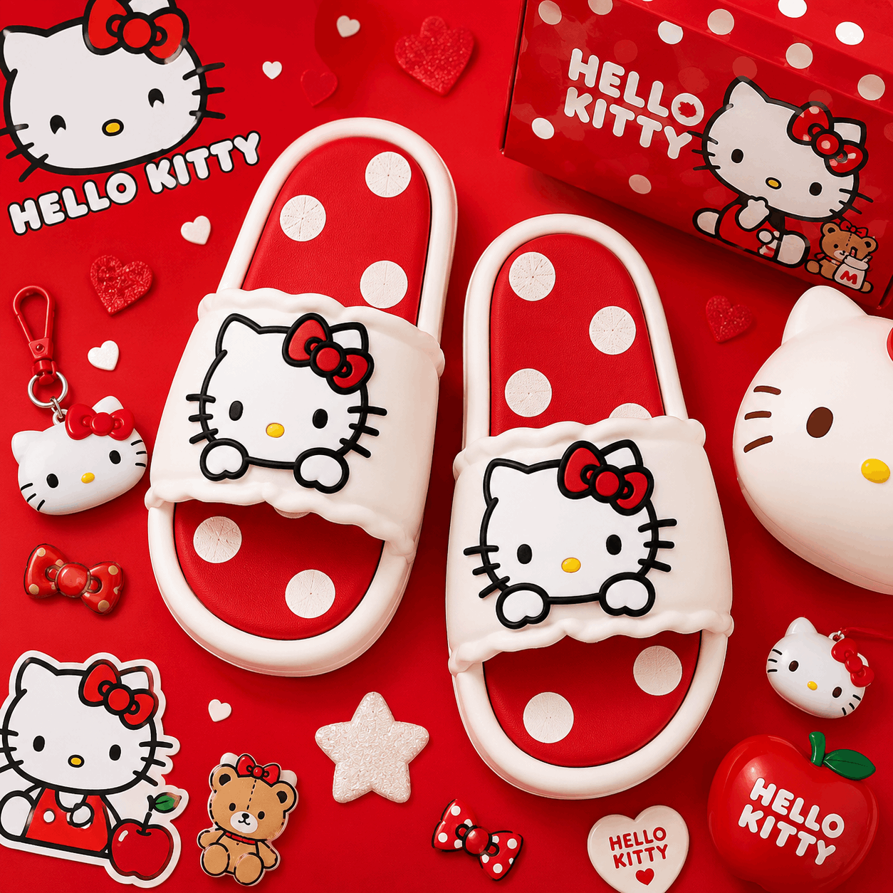 A pair of Hello Kitty slide sandals with white straps, red bows, and red-and-white polka dot soles, arranged on a red background with Hello Kitty-themed accessories and packaging.