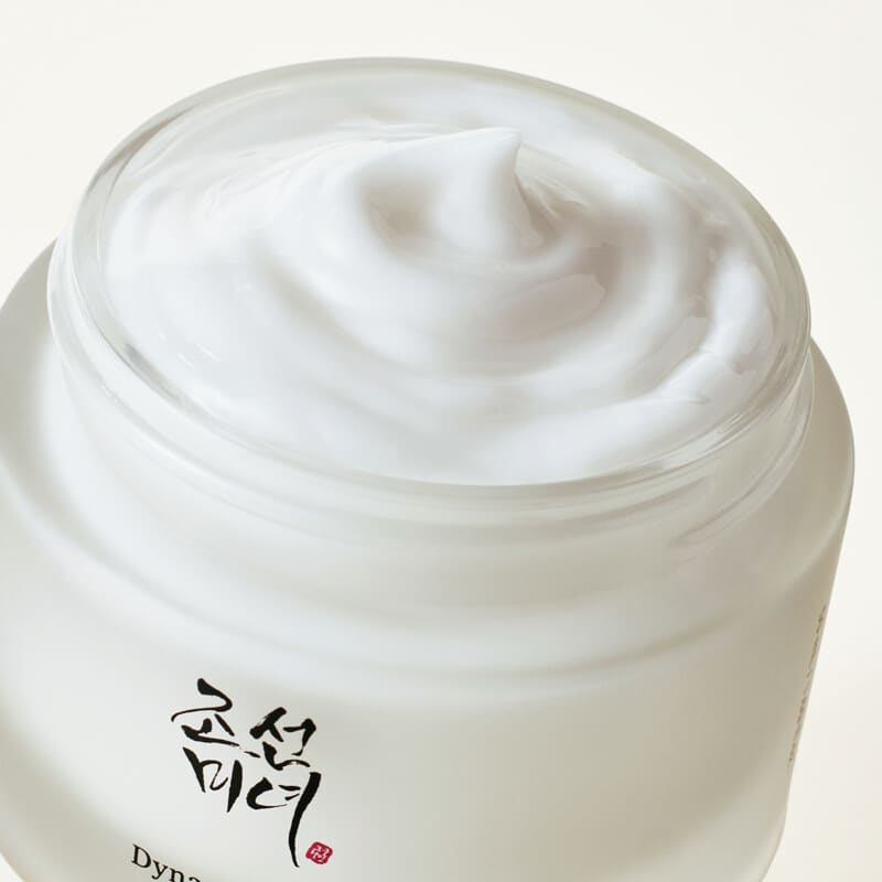 White cream in a jar with a visible brand logo on a white background