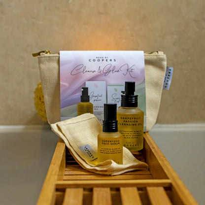Coopers skincare product set with bottles and a pouch on a wooden tray.