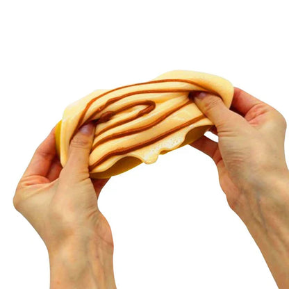 Hands holding a piece of bread with a swirl pattern on a white background