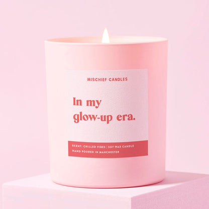 Pink candle with a label on a pink background