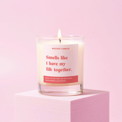 Candle with a humorous label on a pink background