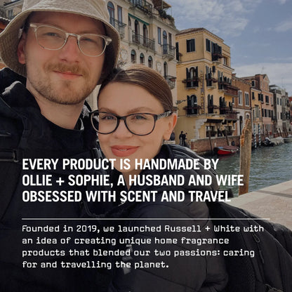 Two people standing in front of a canal with buildings in the background, text overlay about a product brand.