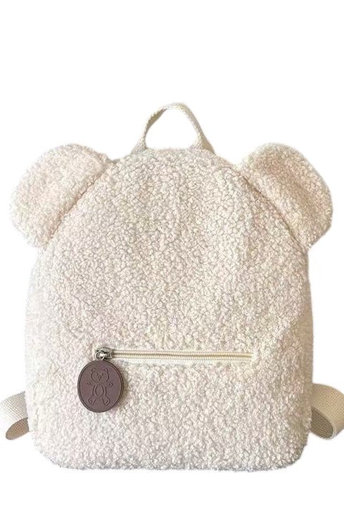 Fluffy white backpack with bear ears and a brown tag on a white background