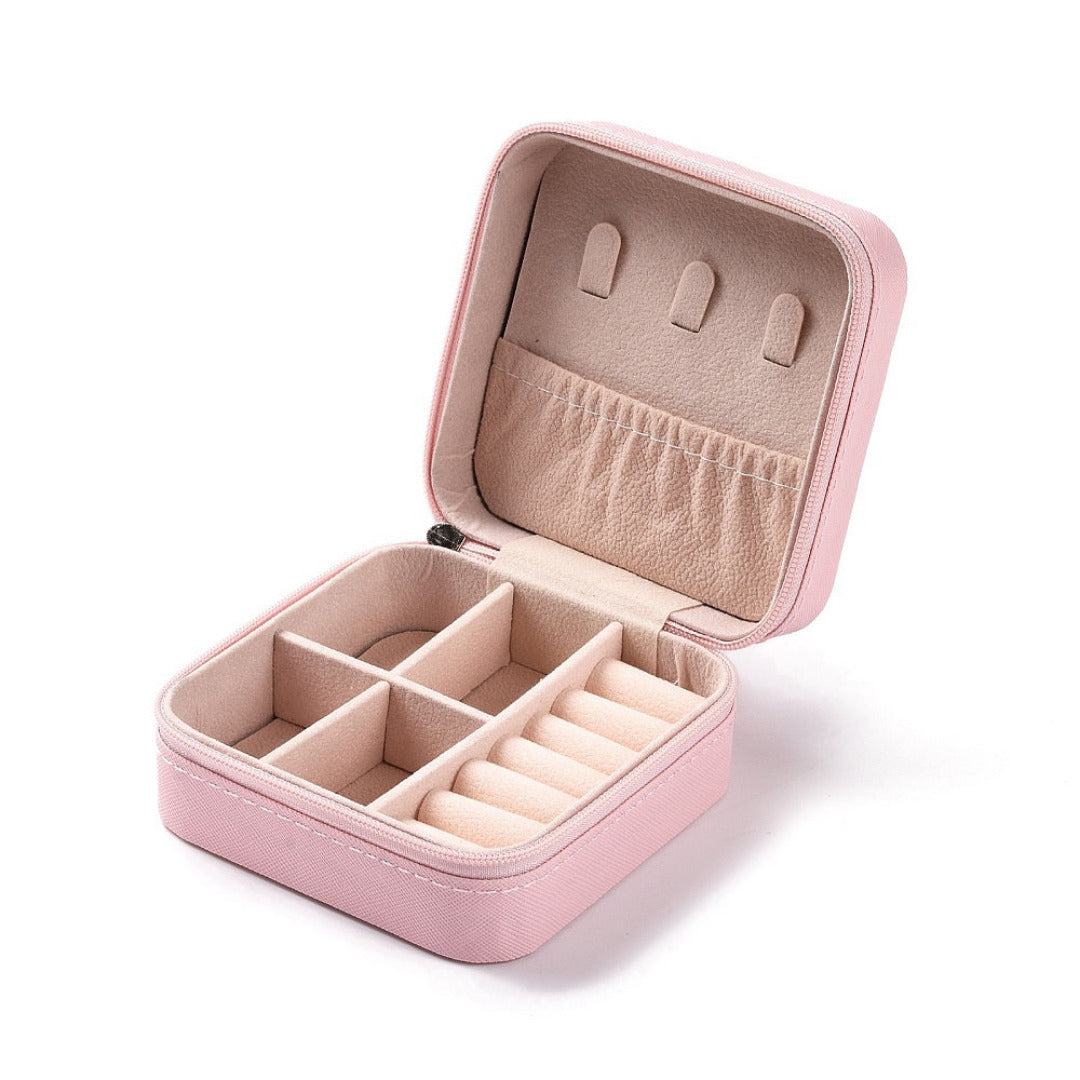 Pink jewelry case with compartments on a white background